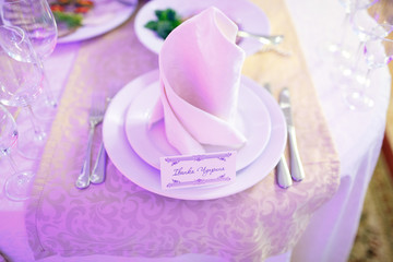 plate with card signed name of guest on white paper