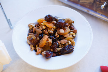 Mix nuts, dry fruits and grapes in white plate