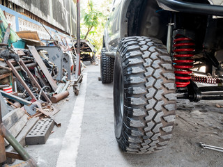 Closeup front wheel and suspension of the four-wheel drive pickup truck.