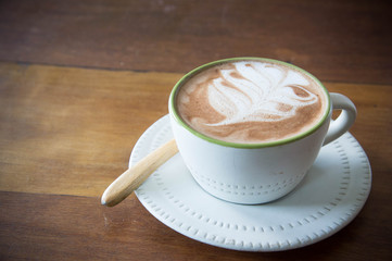 coffee cup and strawberry cake in coffee shop  with wood backgro