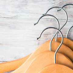 Wooden clothes hangers on bright background. What nothing to wear concept