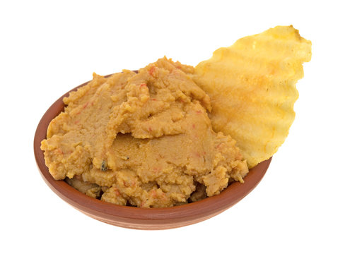 Hummus Dip With A Potato Chip In A Bowl Side View Isolated On A White Background.