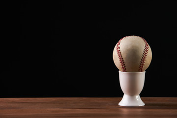 Old vintage baseball on black background with copy space.