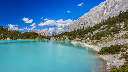Naklejka na ściany i meble Amazing view of Sorapis lake with unusual color of water. Lake located in Dolomite Alps, Italy