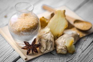 still life of fresh ginger with a wooden spoon  sugar