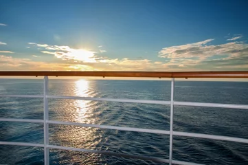 Deurstickers Blick von einem Kreuzfahrtschiff auf die untergehende Sonne im Atlantik © Angela Rohde