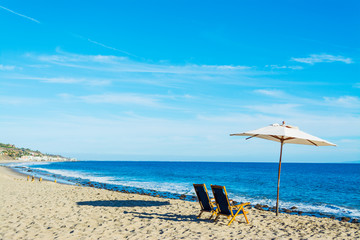 Beach chairs and parasol in Malibu