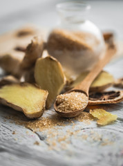 still life of fresh ginger with a wooden spoon  sugar