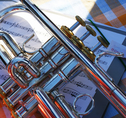Naklejka premium Trumpet on musical score, wind instrument 2