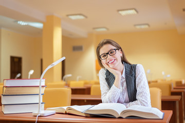 Woman reading book in library