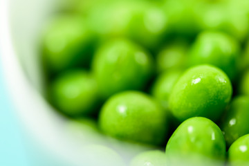 Fresh Green Peas In White Bowl On Turquoise Table
