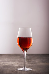 Glass of red wine on wooden table