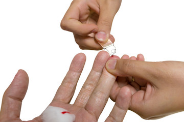 Woman drawing blood from fingertips of man,white isolated.
Close up of female medical technologist hands drawing blood from male donors for Hemoglobin concentration testing.
