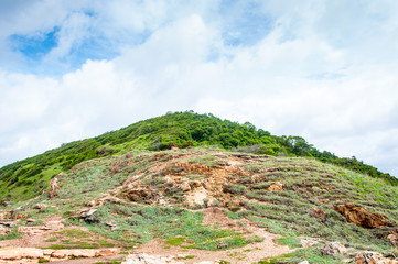 Small hill near an ocean with blue sky
