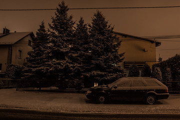 Winter street at night. Snow covered house and car. Background.