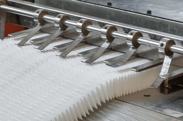 closeup of the machine and equipment are cut and furrowing the felt fabric for automotive filters