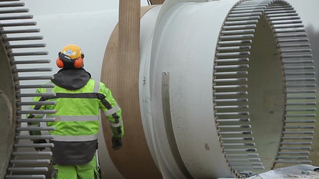 Worker Standing in Front of the Rotor Hub