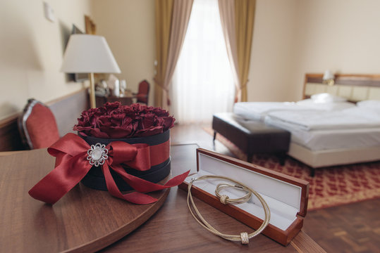 Elegant hotel room with rose decoration and jewels. Romantic weekend concept.