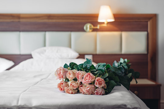 Elegant hotel room with a bouquet of roses. Romantic weekend concept.