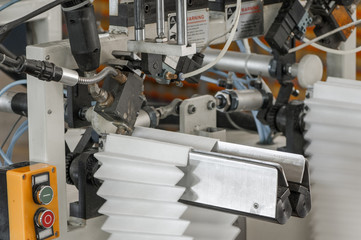 closeup of the machine and equipment are cut and furrowing the felt fabric for automotive filters