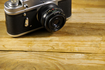 Retro photo camera on a wooden background