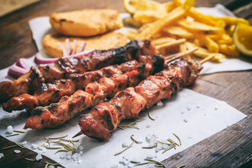 Meat skewers on a wooden background