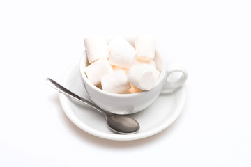 cup with marshmallow on plate with spoon