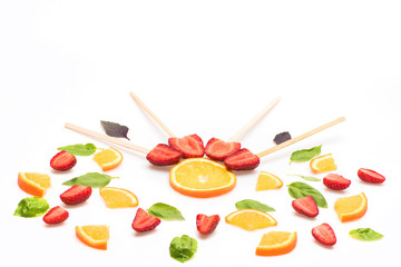 strawberry, green mint leaves and orange isolated on white