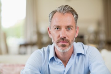 Confident man sitting in living room