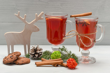 chocolate cookies and mulled wine with cinnamon in metallic mug