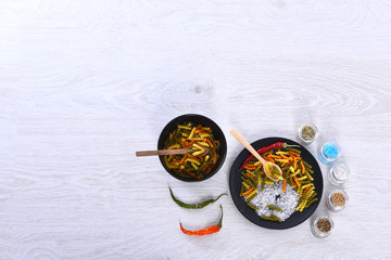 plates with pasta, spoons, spices in jars, chili pepper