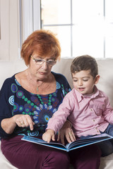 Grandmother reading a story to her grandson