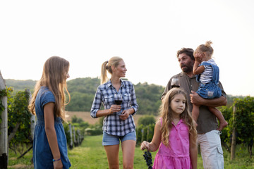Fototapeta premium Wine grower family in vineyard before harvesting