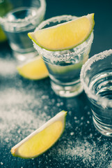 Silver Mexican tequila with lime and salt, toned picture, selective focus, close up