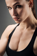 Naklejka premium Portrait of active woman posing on grey background