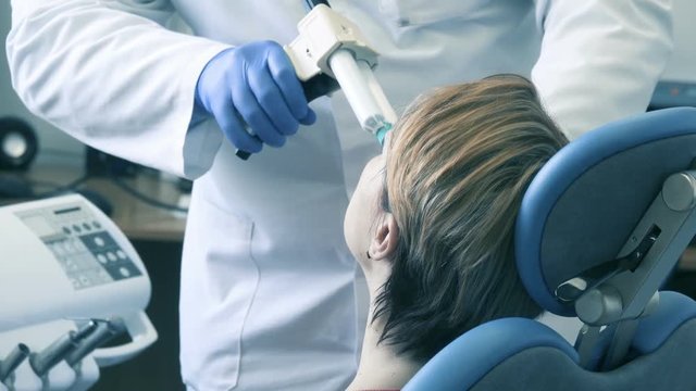 Dentist injects the gel into the mouthpiece in the patient's mouth for tooth imprint