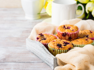 Berry muffins in wooden tray napkin textile. Spring summer holiday breakfast set with tea