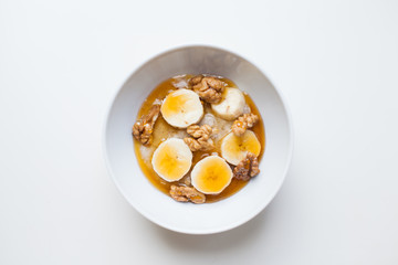 oatmeal with honey and walnuts on a white background