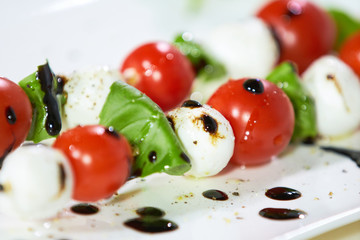 appetizer of cherry tomatoes, mozzarella, basil and sauce