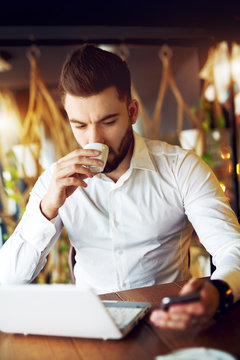 Businessman drinking coffee.