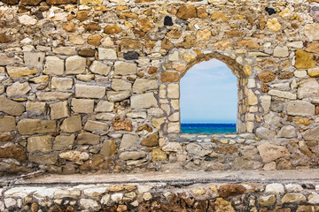Fototapeta na wymiar Stone ancient wall with a window