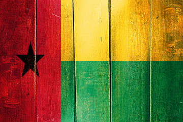 Vintage Guinea bissau  flag on grunge wooden panel