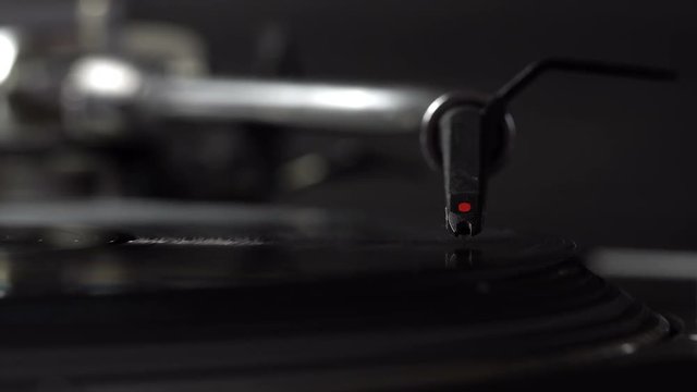 DJ needle on spinning turntable. Listening the music



