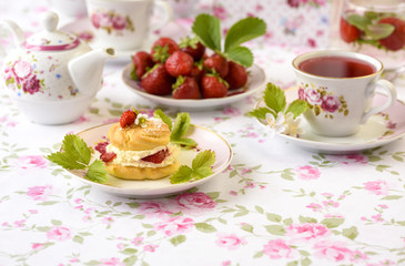 Profiterole or cream puff cakes or filled with whipped cream,g served with strawberries