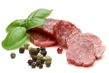 Salami smoked sausage slices, basil leaves and peppercorns isola