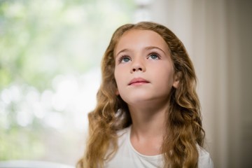 Close-up of thoughtful girl looking up