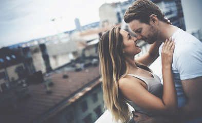 Romantic couple kissing on rooftop