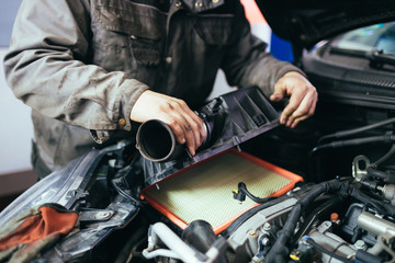 Fototapeta na wymiar Auto mechanic repairing car. Selective focus.