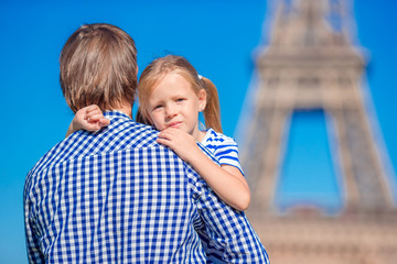 Fototapeta na wymiar Happy family in Paris background Eiffel Tower. Dad and little girl on french vacation.