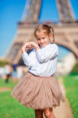 Portrait of little girl in Paris background the Eiffel tower